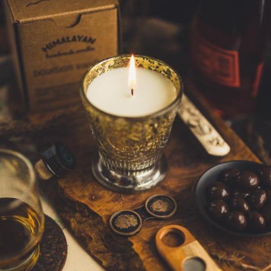 Light candle on wooden backdrop