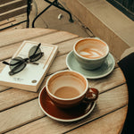 Cafe table with espressos and book